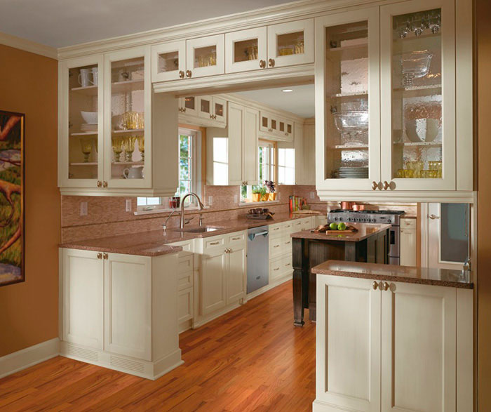 Off white cabinets in casual kitchen by Kitchen Craft Cabinetry